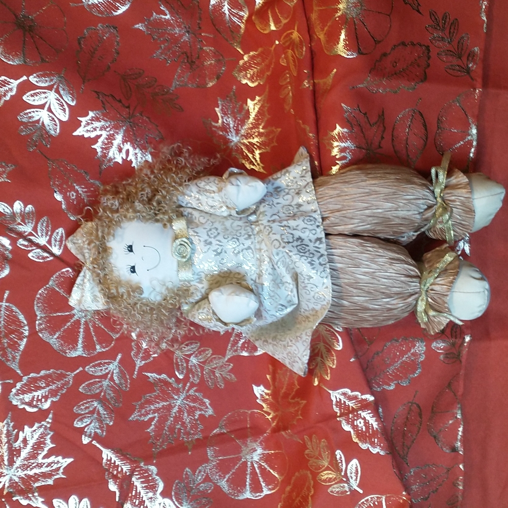Vintage shelf sitting shimmering gold and cream colored doll